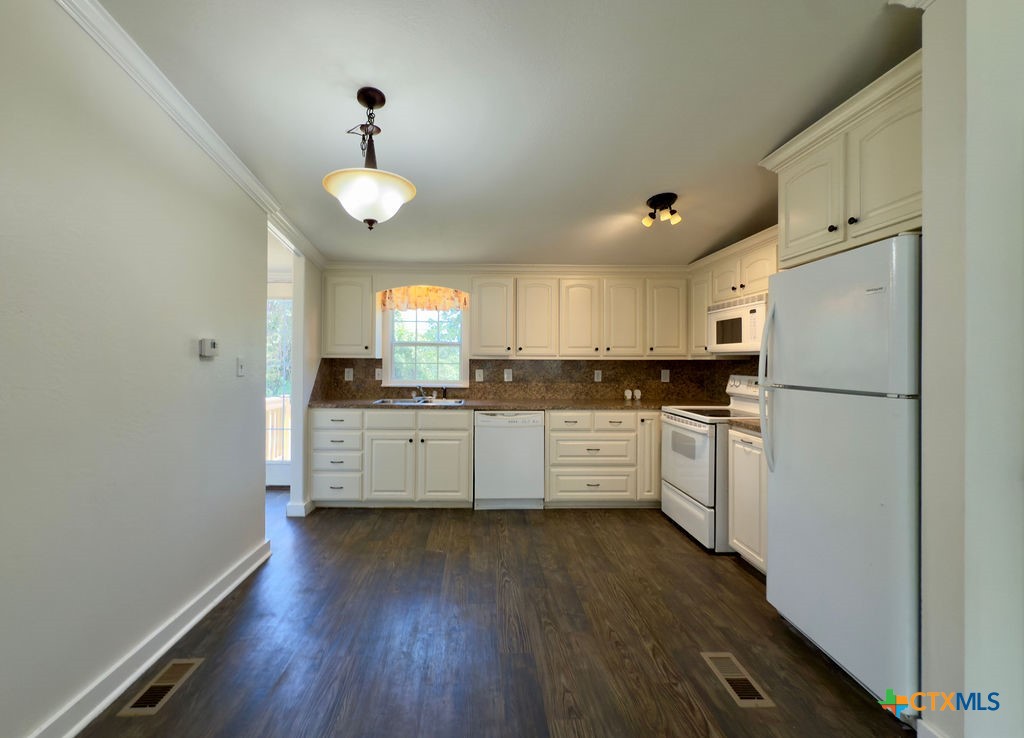 375 Alto Lane Waco, TX 76705 - Photo 12 of 27 a kitchen with white cabinets and stainless steel appliances