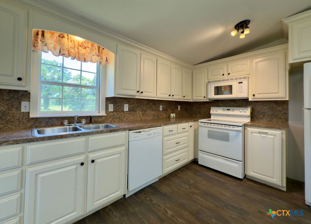 375 Alto Lane Waco, TX 76705 - Photo 14 of 27 a kitchen with granite countertop white cabinets white stainless steel appliances and sink