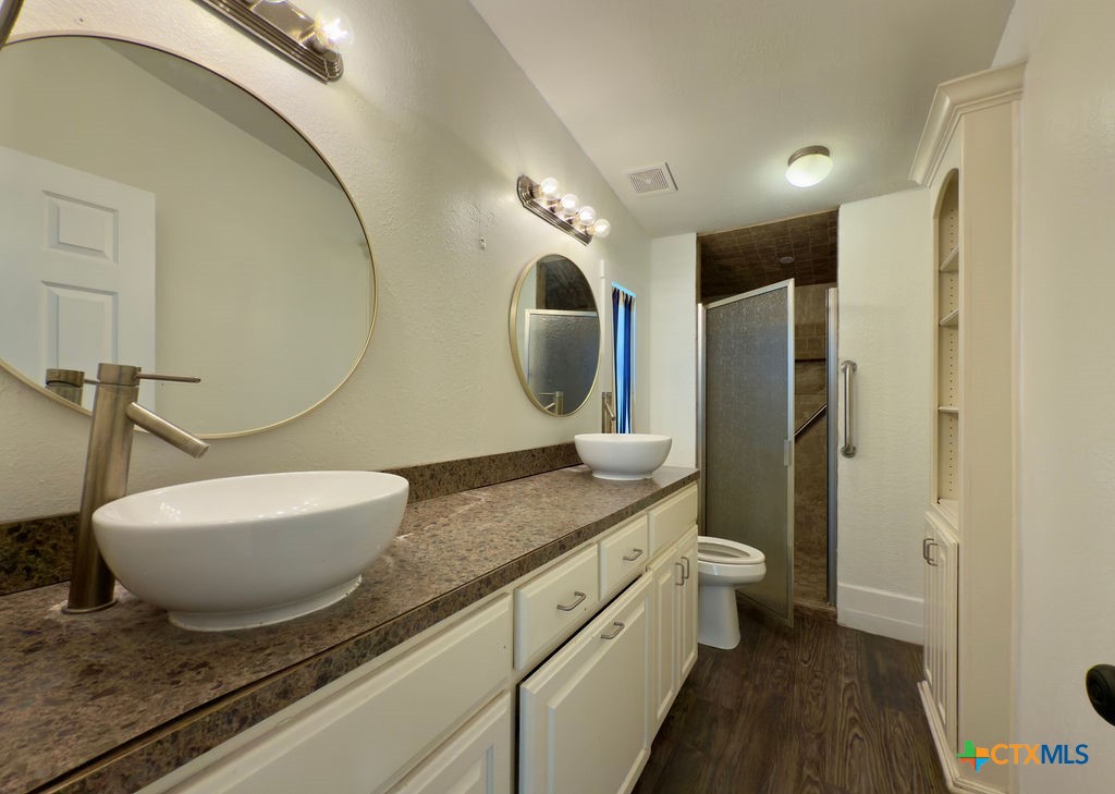 375 Alto Lane Waco, TX 76705 - Photo 19 of 27 a spacious bathroom with a granite countertop sink and a mirror