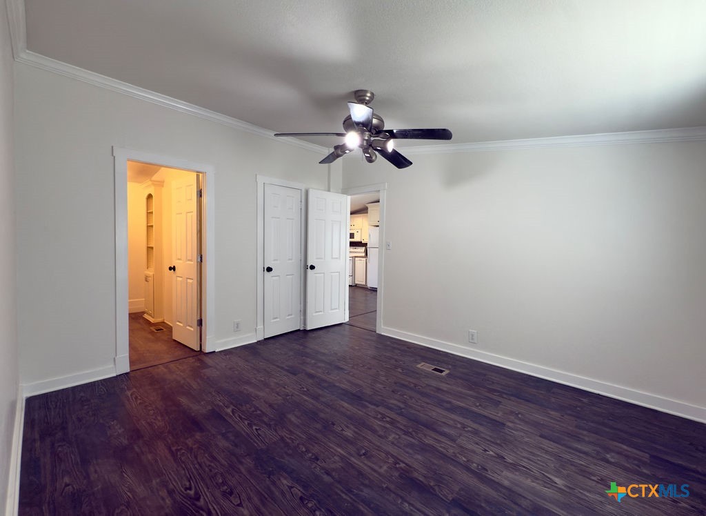 375 Alto Lane Waco, TX 76705 - Photo 21 of 27 a view of an empty room with chandelier fan and wooden floor