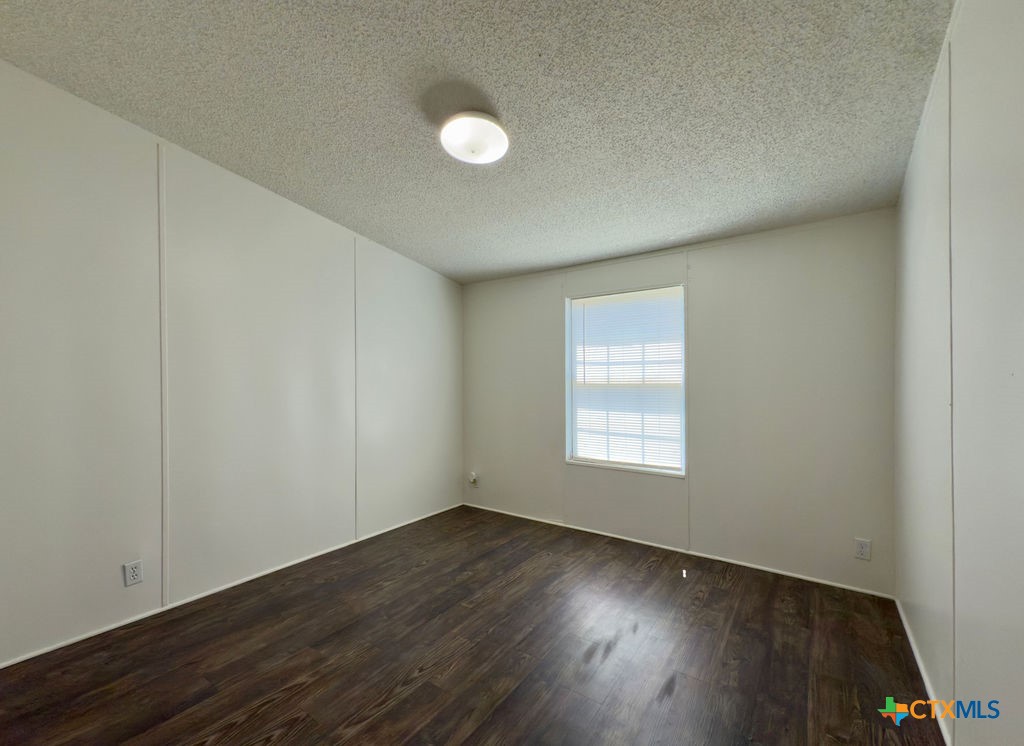 375 Alto Lane Waco, TX 76705 - Photo 24 of 27 an empty room with wooden floor and windows