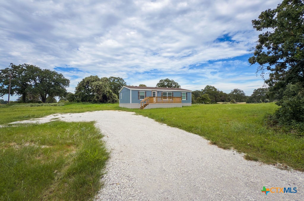 375 Alto Lane Waco, TX 76705 - Photo 3 of 27 a view of a lake with a big yard and large trees