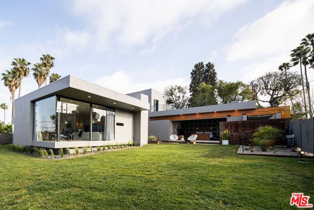 a view of a house with a yard porch and sitting area