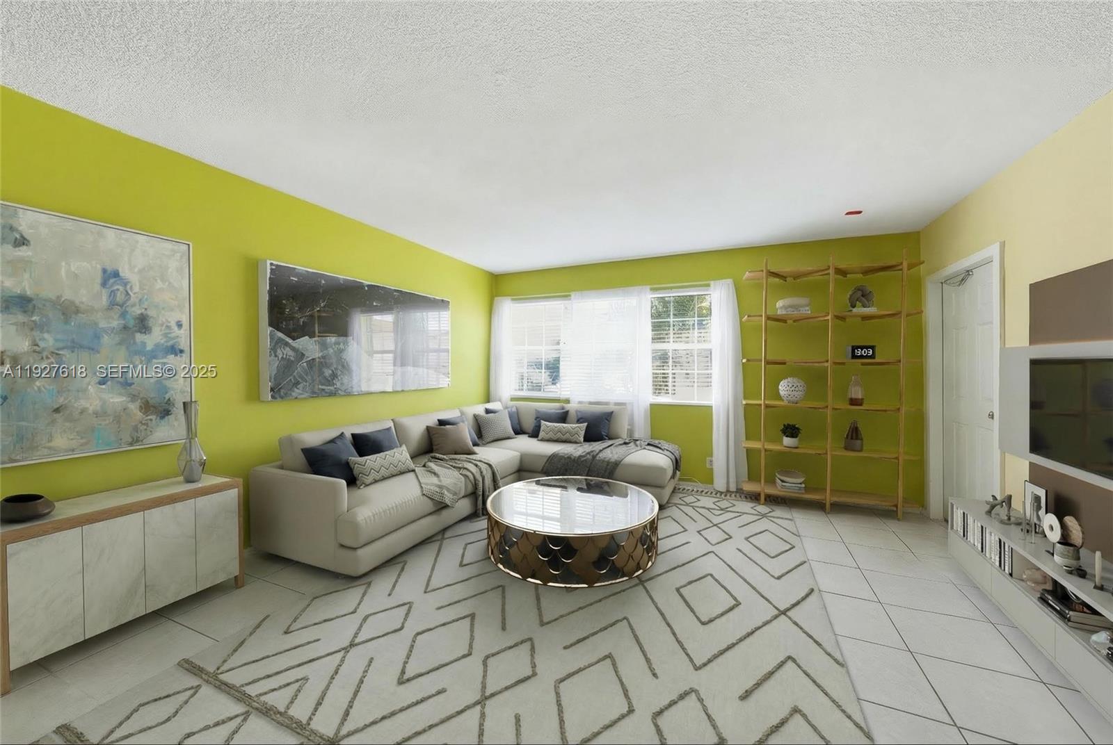 221 Southeast 9th Avenue, Unit 202 Pompano Beach, FL 33060 - Photo 2 of 19 a living room with furniture and a flat screen tv