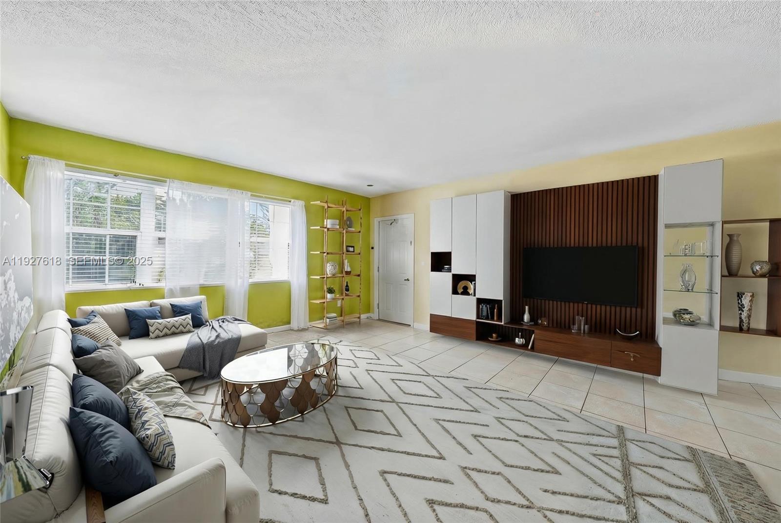 221 Southeast 9th Avenue, Unit 202 Pompano Beach, FL 33060 - Photo 3 of 19 a living room with furniture and a flat screen tv