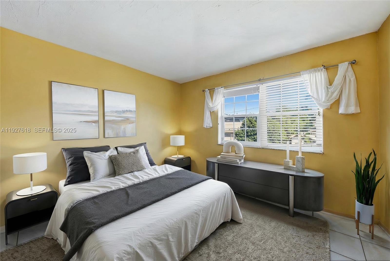 221 Southeast 9th Avenue, Unit 202 Pompano Beach, FL 33060 - Photo 5 of 19 a bedroom with a bed and a window