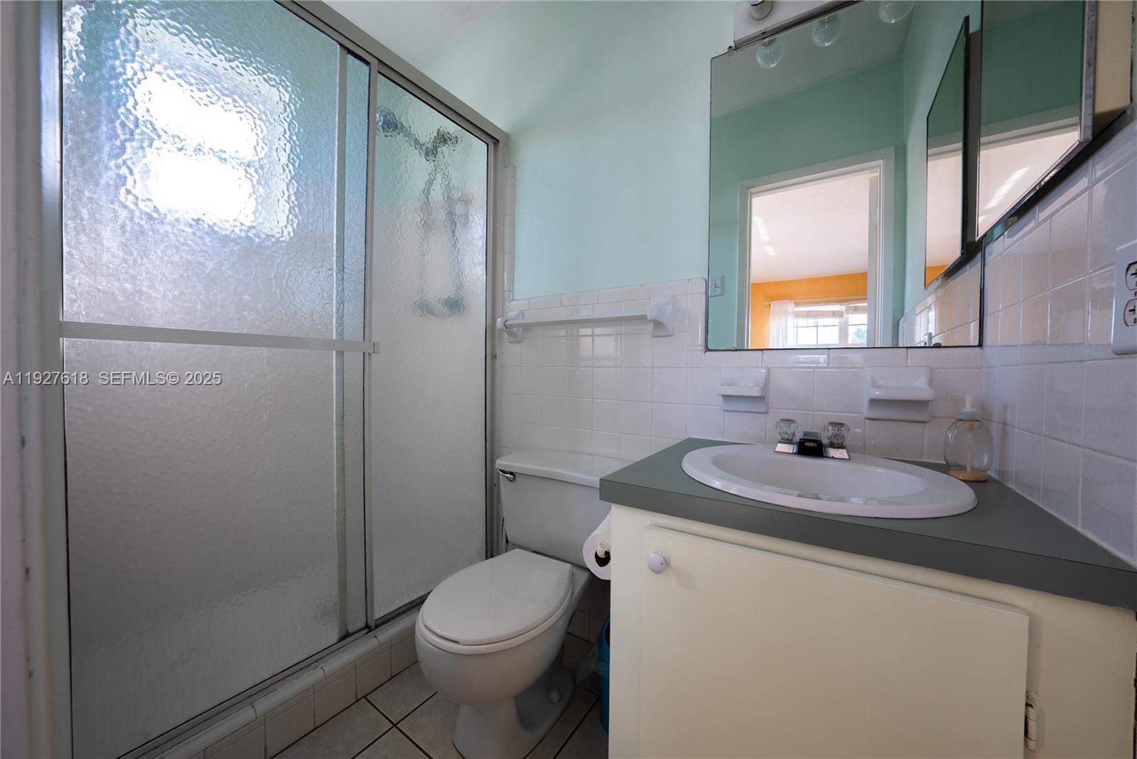 221 Southeast 9th Avenue, Unit 202 Pompano Beach, FL 33060 - Photo 8 of 19 a bathroom with a sink toilet and shower