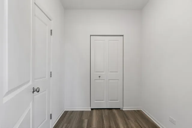 a view of front door with wooden floor