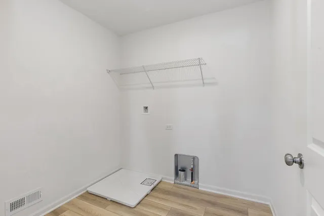 a view of a room with a sink and cabinets