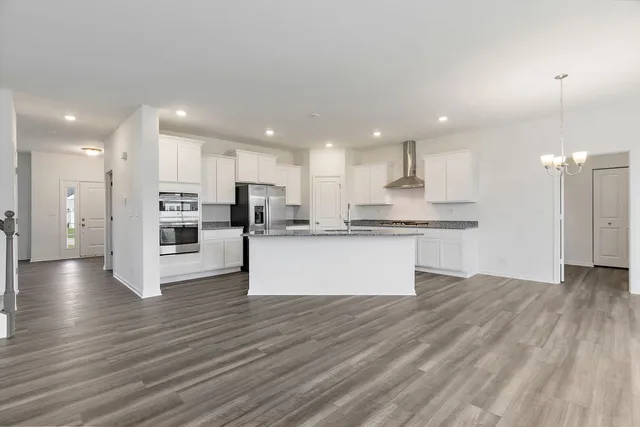 a view of kitchen with kitchen island and stainless steel appliances