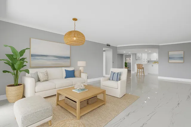 a living room with furniture a chandelier and a floor to ceiling window