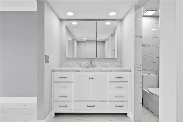a bathroom with a sink a vanity a large mirror and shower