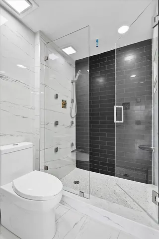 a bathroom with a toilet a shower and a sink