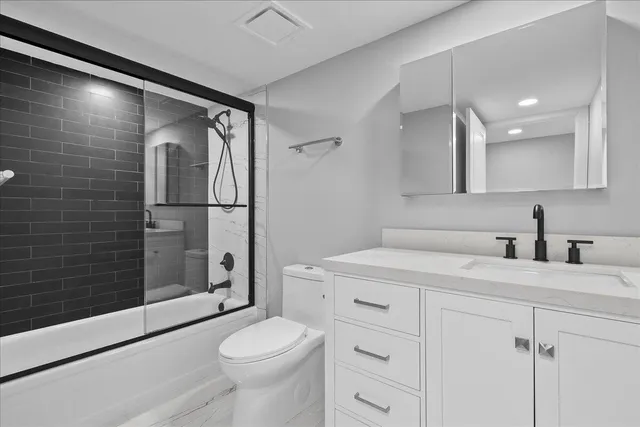 a bathroom with a sink toilet and shower