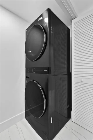 a view of a white house with a small yard and palm trees