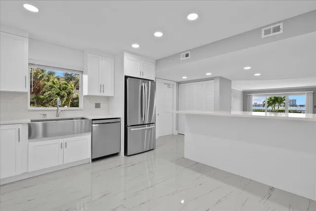 a view of kitchen with furniture and refrigerator