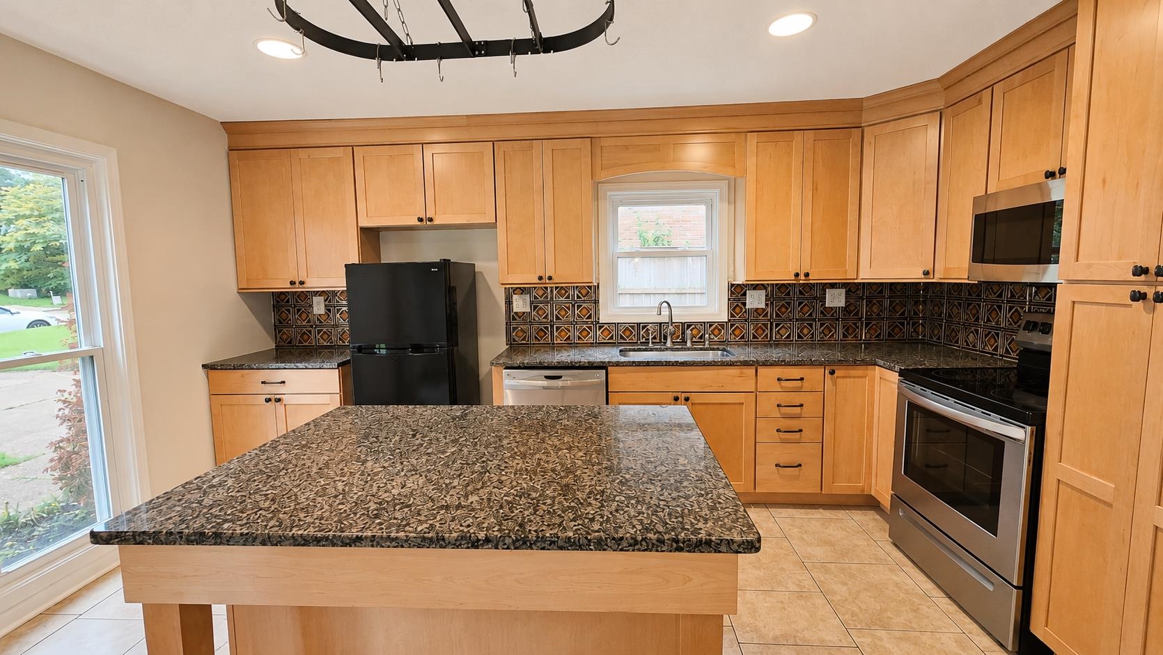 89 Ericson Road Memphis, TN 38018 - Photo 9 of 36 a kitchen with kitchen island granite countertop a stove refrigerator and microwave