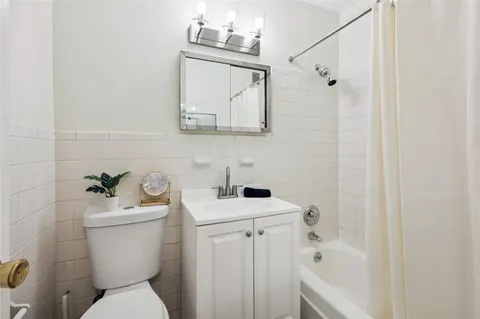 a bedroom with a bed and a potted plant