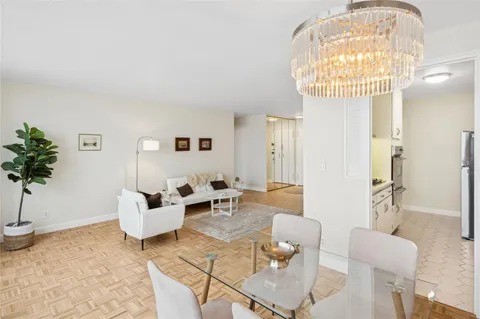 a living room with furniture and a chandelier