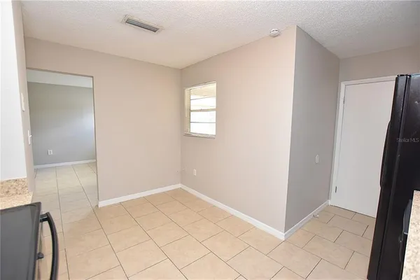 a living room with furniture wooden floor and a large window