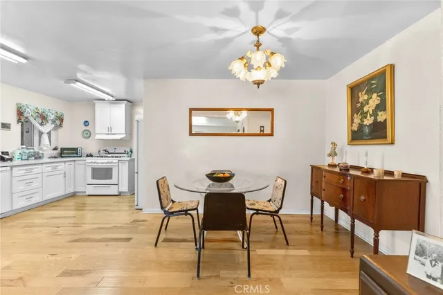 a view of a dining room with furniture and chandelier