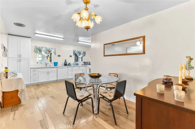 a dining room with furniture and chandelier