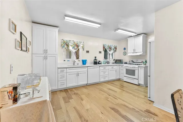 a kitchen with stainless steel appliances a sink and cabinets