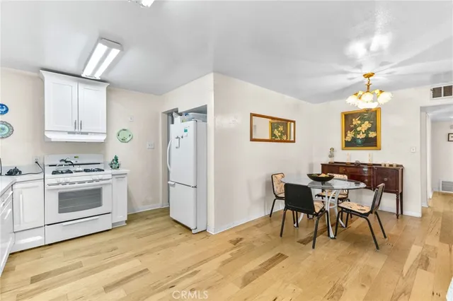 a living room with stainless steel appliances kitchen island granite countertop furniture and a dining table