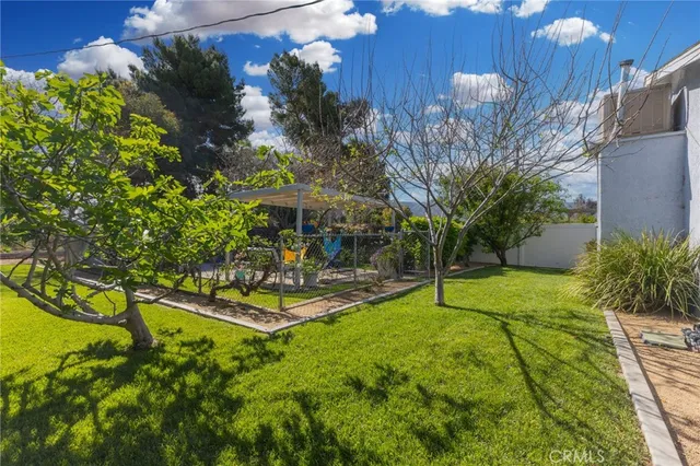 a view of an house with backyard and sitting area