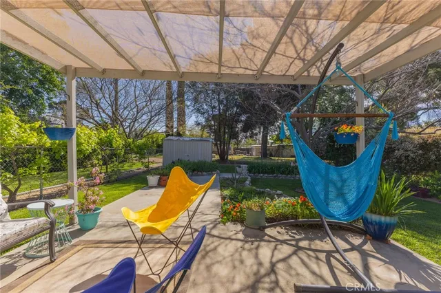 a view of a backyard with plants and a patio