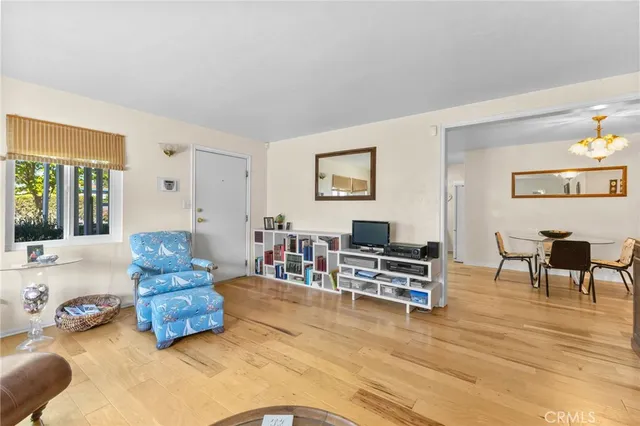 a bedroom with furniture and wooden floor