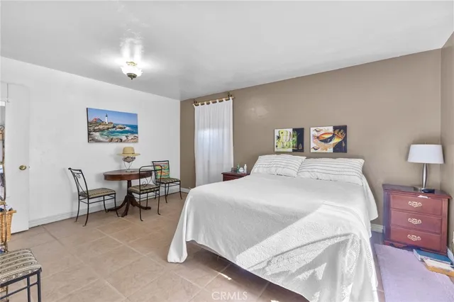 a bedroom with a bed and a table