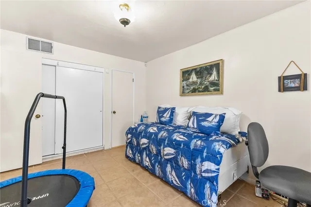 a bedroom with bed and a chandelier