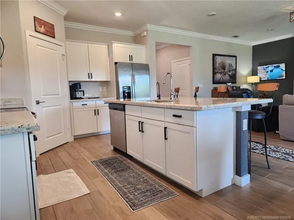 a kitchen with appliances a sink a counter top space and cabinets