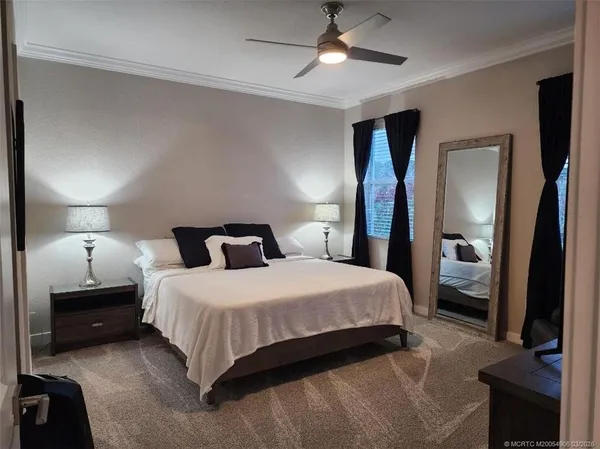 a bedroom with a bed and a mirror