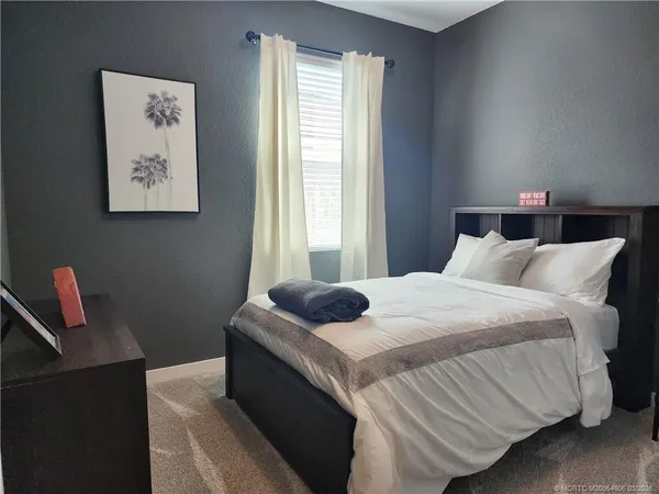 a bedroom with bed and window