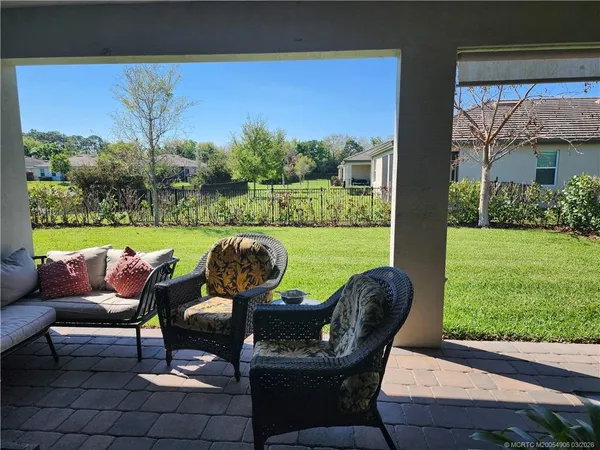 a view of a porch with furniture and a yard