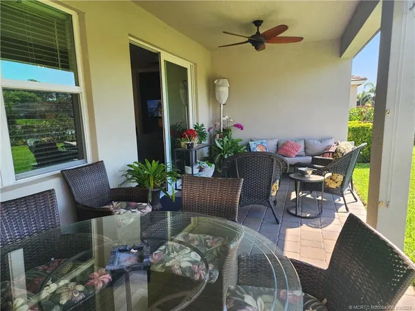 a living room with furniture and flowers
