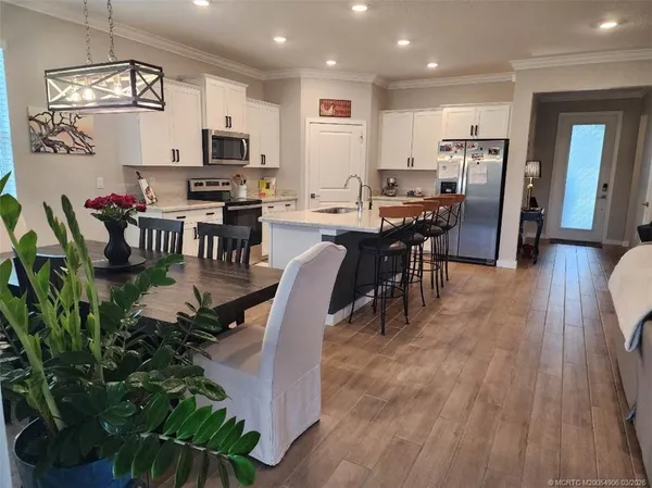 an open kitchen with kitchen island and stainless steel appliances
