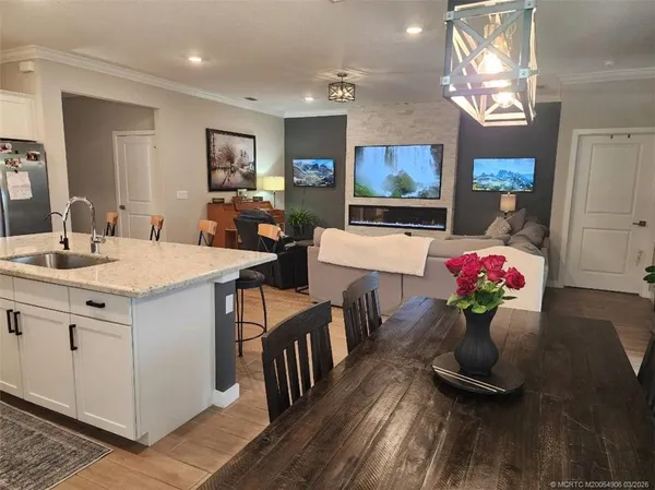 a room with furniture a flat screen tv and a chandelier