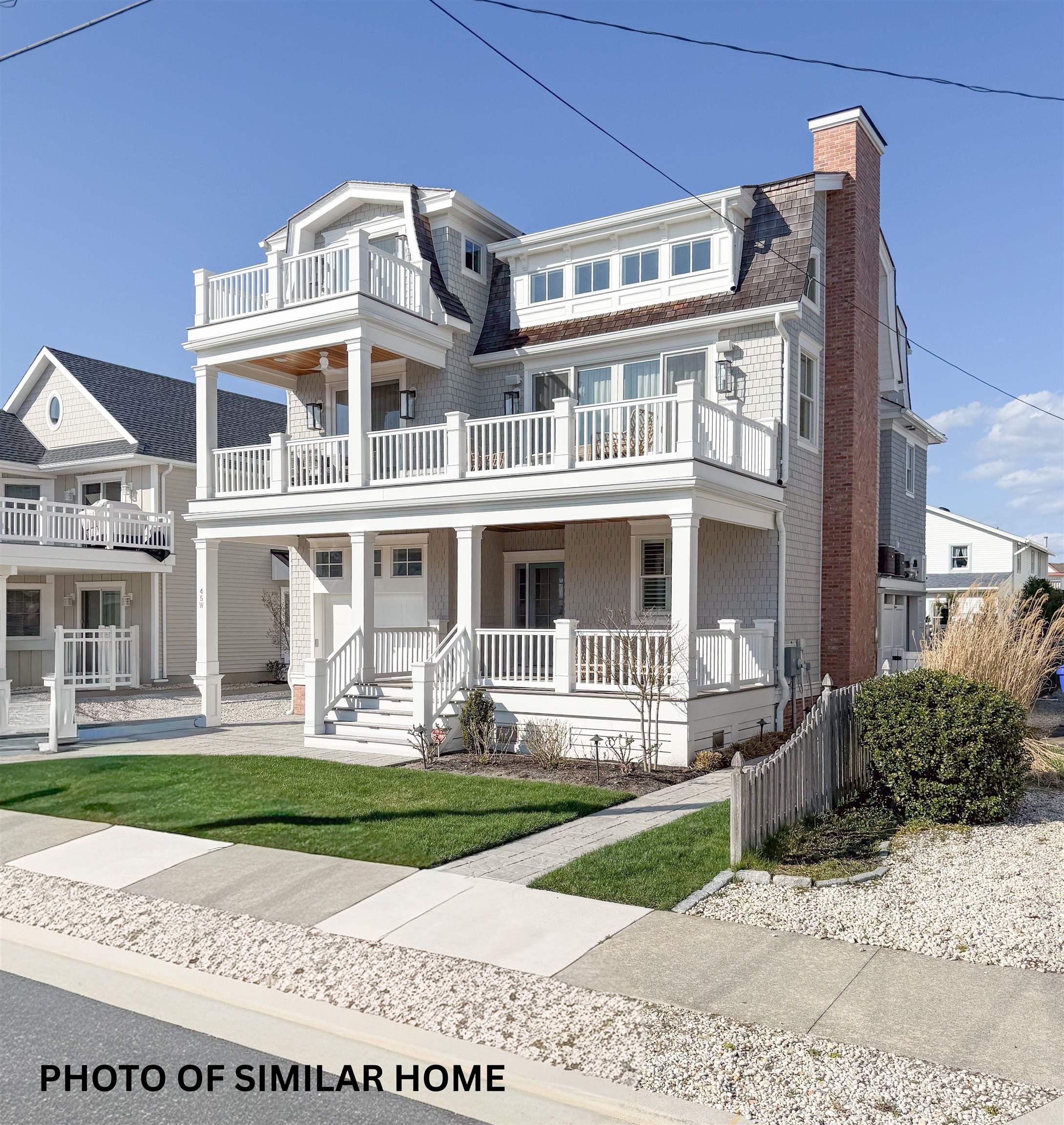 76 21st Street Avalon, NJ 08202 - Photo 3 of 4 a front view of a house with garden and porch