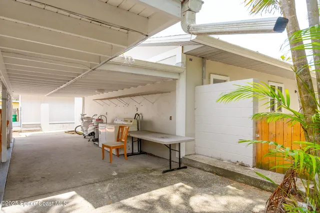 a kitchen with stainless steel appliances a sink a stove a refrigerator cabinets and a window