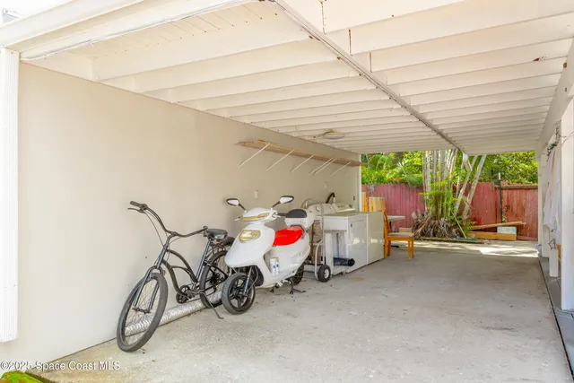 a living room with a flat screen tv and a floor to ceiling window