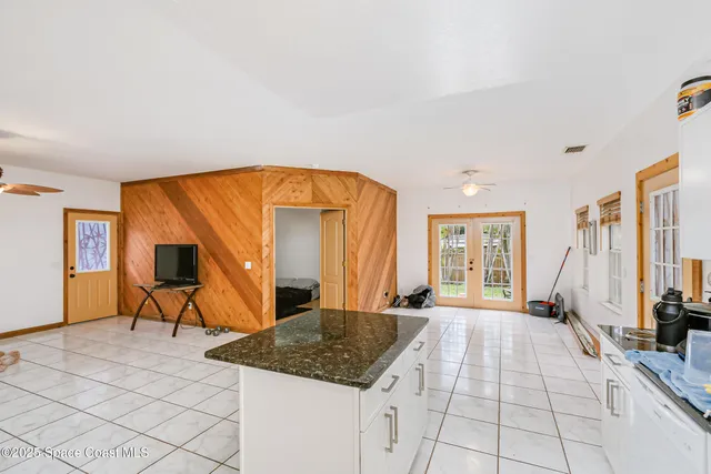 a bathroom with a granite countertop sink a toilet and a mirror