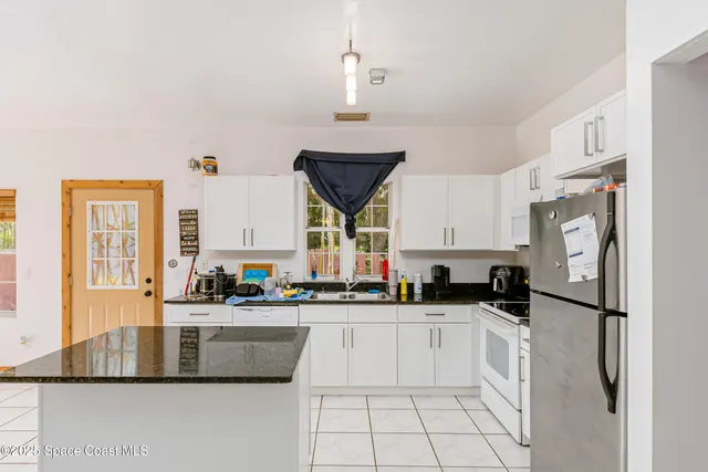 a kitchen with a sink appliances and cabinets