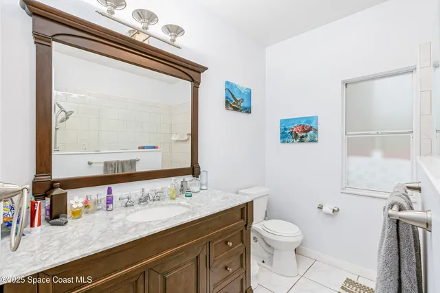 a kitchen with granite countertop white cabinets and stainless steel appliances