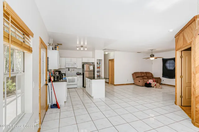 a bedroom with furniture and a flat screen tv