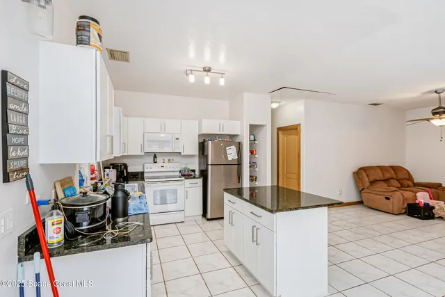 a kitchen with stainless steel appliances a stove a sink dishwasher and cabinets with wooden floor
