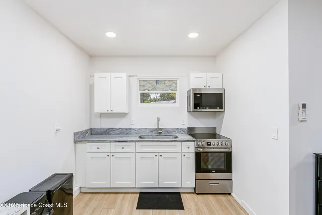 a dining room with furniture and a window