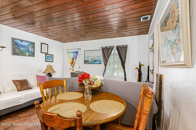 a view of a house with a swimming pool and a large tree